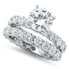 a white gold diamond ring and wedding band set with round brilliant cut diamonds in the center