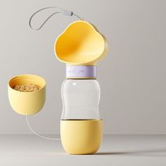 a yellow and white glass bottle with an orange lid next to a yellow cup filled with cereal