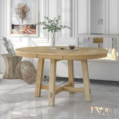 a round wooden table in a white room