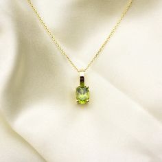 14k solid gold natural oval green peridot set in a simple 4 prong setting. the peridot is 8 mm by 6 mm 1.42 ct total weight . the pendant is 12 mm from top to bottom. available in 14 k white gold , 14 k yellow gold and 14 k rosegold. the pendant can be purchased without the chain if you have your own. Material: 14k solid gold Gemstone: natural peridot 8 mm by 6 mm 1.42 ct  pendant size 12 mm by 6 mm FREE shipping within the US. Comes in a gift box.   ALL OF MY JEWELRY IS HANDMADE AND DIAMOND SET Peridot Necklace, Everyday Necklace, Green Peridot, August Birth Stone, Diamond Sizes, Gold Pendant, Solid Gold, My Jewellery, Diamond Cuts