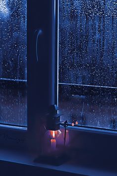 a candle is lit in front of a window with rain falling down on the windowsill