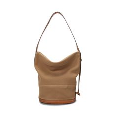 This slouched version of our Bellport bucket bag is designed with an adjustable strap that allows for styling as a sling or shoulder bag. Crafted with wool-blend flannel and full-grain leather trim the versatile silhouette showcases highly considered details including a top zip closure engraved brass hardware and a structured circular base. It’s accented with our gold foil-embossed signature logo for an unmistakable Polo finish. Brown Canvas Bucket Bag With Leather Trim, Brown Coated Canvas Bucket Bag With Leather Handles, Modern Bucket Bag With Leather Trim Tote, Leather Trim Bucket Shoulder Bag For On-the-go, Modern Bucket Bag With Leather Trim, Modern Travel Hobo Bag In Bucket Shape, Modern Travel Hobo Bag With Bucket Shape, Large Capacity Bucket Shoulder Bag In Coated Canvas, Large Capacity Coated Canvas Bucket Shoulder Bag