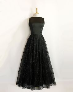 "This stunning full length bridal overskirt is made from our beautiful 3D Peggy Lace. It is a generous full-circle skirt with an extra layer of tulle underneath for extra volume and a high fitted waistband in satin crepe. It is seen here in a dramatic black but can also be made in ivory. Photographed in black with the Elvira Wedding Gown in Black Satin Crepe: https://www.etsy.com/uk/listing/1403872161/elvira-wedding-gown-in-black-satin-crepe?click_key=75e96a7c5c1443f514a630a1b8cd8b2087eaa4a8%3A1 Black Full-length Wedding Gown, Black Full-length Gown For Wedding, Elegant Floor-length Ball Gown With Tulle Skirt, Full Length Party Dress With Tulle Skirt, Full Length Tulle Skirt Party Dress, Full-length Tulle Dress For Party, Full Length Tulle Dress For Party, Full Length Tulle Skirt Dress For Party, Elegant Evening Gown With Flowy Skirt