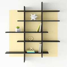 a book shelf with books and other items on it, along with a star hanging from the wall