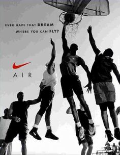 a group of men jumping up into the air to dunk a basketball ball in front of an advertisement for nike