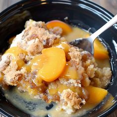 a close up of a bowl of food with peaches and crumbled toppings