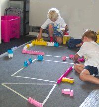 two children playing with toys on the floor