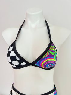 Unleash Your Funky Flow with this Unique Rave Bralette!  This eye-catching top comes in two electrifying styles: a bold checkered wrap bralette or a swirling tie-dye masterpiece. Crafted for comfort and confidence, it's the perfect foundation for your next festival adventure. Embrace the Funky Spirit: Two Groovy Styles: Choose between a classic checkered pattern or a mesmerizing tie-dye design to match your unique vibe. Flattering OPTIONAL Wrap Design: The adjustable wrap style offers a customiz Trendy Fitted Halter Top For Festival, Fitted Rave Swimwear For Music Festival, Multicolor Triangle Halter Top For Festival, Trendy Multicolor Crop Top For Festival, Fitted Rave Swimwear, Rave Style Halter Top For Summer Festivals, Summer Rave Festival Halter Top, Rave Style Summer Festival Halter Top, Summer Rave Style Halter Top For Festivals