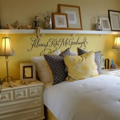 a bedroom with yellow walls and pictures on the wall