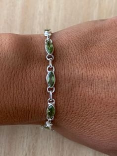 Lovely faceted peridot and sterling silver bracelet. The bracelet has 10 individual faceted peridot stones in marquise shape.  The bracelet measure 19.5 cm long and it is almost 0.5 cm wide. The bracelet can be  easily  adjusted from 19.5 cm to 18.5 cm.  The high quality of our stones is what it makes this bracelet so precious. The peridot is faceted to add the extra shining and elegance to the bracelet.  A perfect present for her on any occasion St Valentine Day, Birthday, Anniversary, or Chris Peridot Bracelet, August Birthstone, Dope Jewelry, Bracelet Chain, Classy Jewelry, Funky Jewelry, Jewelry Lookbook, Green Peridot, Mens Accessories Jewelry