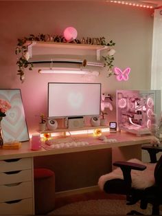 a desk with a monitor, keyboard and chair in front of a wall mounted screen