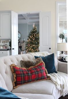 a living room filled with furniture and a christmas tree