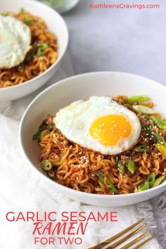 two white bowls filled with noodles and an egg on top, next to a fork