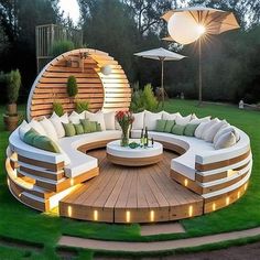 a circular couch sitting on top of a lush green field