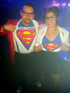 the man and woman are dressed up as supermans