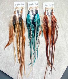 three different colored feathers are sitting on a table