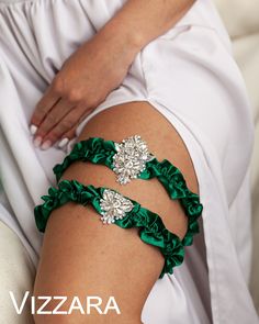 a woman wearing green garters and bracelets on her thigh with the word verara written in white