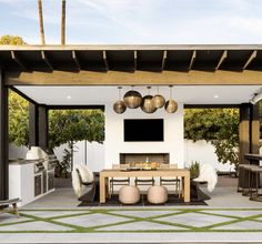 an outdoor kitchen and dining area is featured in this rendering by the company's design team