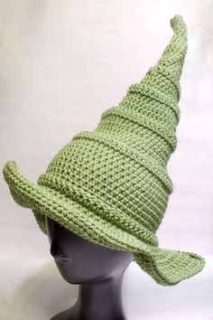 a crocheted green hat on top of a mannequin's head