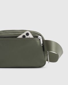 Here’s a unique way to bottle up waste. We transformed 4 plastic bottles into a super functional (and totally stylish) belt bag. Whether you're going for a walk, running errands, or attending a music festival, our Revive Nylon Belt Bag is the ideal accessory to keep your hands free and your belongings secure. Our premium, silky smooth nylon is ultra-durable, water-resistant, and lightweight, making it perfect for daily use.  | Quince | Women's Revive Nylon Belt Bag in Olive Functional Belt Bag For Daily Use, Modern Belt Bag With Removable Pouch For Outdoor Activities, Green Nylon Belt Bag For Everyday Use, Modern Belt Bag With Removable Pouch For Outdoor, Versatile Nylon Pouch Belt Bag, Sporty Green Belt Bag For Travel, Versatile Nylon Belt Bag, Versatile Green Belt Bag, Functional Green Belt Bag With Removable Pouch