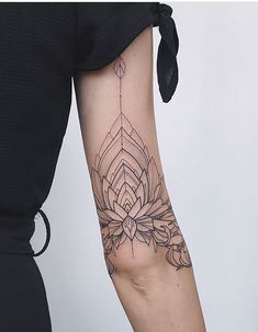 a woman's arm with a flower tattoo on the left side of her arm