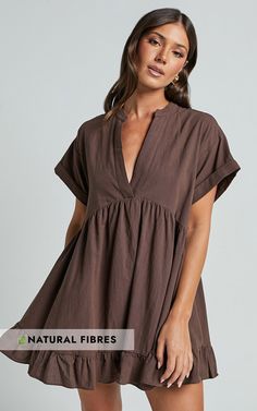 Calling all fashionistas! Get ready to turn heads in the Calissa Mini Dress - Frill Hem Smock Dress In Chocolate. This stunning brown smock dress is perfect for those casual days when you want to look effortlessly chic. Made from 100% cotton, this dress is not only comfortable but also breathable, making it ideal for warmer weather. The V neck and short sleeves add a touch of femininity, while the frill hem adds a fun and flirty flair. Whether you're headed to brunch with your girls or out for a Brown Smocked Back Dress For Vacation, Brown Vacation Dress With Smocked Back, Vacation Brown Dress With Smocked Back, Brown V-neck Mini Dress For Day Out, Brown Smocked Back Dress For Brunch, Brown Dresses With Smocked Back For Brunch, Brown Dress With Smocked Back For Brunch, Brown Relaxed Fit Cotton Dress, Brown Dress With Smocked Back For Daywear