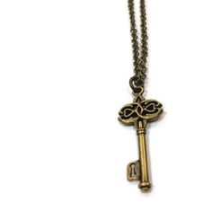 This key necklace created by Jewelry By Luet and Co is made of:  a brass skeleton key, brass:  chain, lobster claw clasp and findings.  This necklace measures 18 1/4 inches in length.WE OFFER FREE STANDARD SHIPPING WITHIN THE UNITED STATES.All of our jewelry is unique and custom designed. We would love to assist you with any custom orders or needs for special occasions!We appreciate you shopping with Jewelry By and Luet and Co and hope you will do so often!See more items from my shop: http://www Metal Key Necklace Perfect As Gift, Steampunk Jewelry With Keys For Gifts, Bronze Brass Necklace With Keys, Vintage Brass Necklaces With Two Keys, Vintage Gold Necklaces With Keys, Vintage Gold Key Necklace, Gold Brass Necklace With Keys, Antique Gold Necklaces With Two Keys, Chain Jewellery