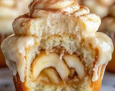 a close up of a cupcake with icing and cinnamon swirls on top