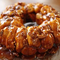 a bundt cake covered in caramel and pecans