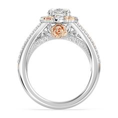 an engagement ring with two tone gold and white diamonds on the sides, set in 18k