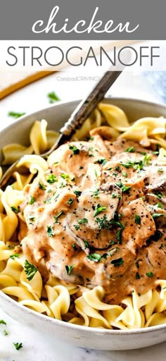 chicken stroganonoff in a white bowl with a fork on the side