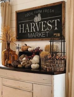 a sign that says harvest market hanging on the wall above a buffet with pumpkins and gourds