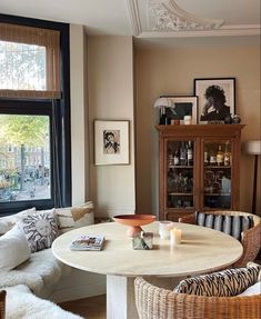 a living room filled with furniture next to a window