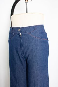 "Vintage 1970s dark wash denim light weight ankle length flared jeans. High waist, relaxed fit. Large belt loop flaps. No pockets. V seam rear. Orange top stitching. Zipper and snap button fly. Label: none Measurements: Waist: 28\" Hip: 36\" taken 7\" below the waist Length: 36.5\" Inseam: 25.5\" Rise: 11.5\" Condition: Excellent. Please do not hesitate to convo with any questions. We upload large pictures - Simply click on each picture for a closer look. More VINTAGE from DEJAVINTAGE here... ht Retro Wide Leg Flare Jeans In Rigid Denim, Denim Blue Flare Jeans With Belt Loops, Vintage High Waist Flare Jeans In Rigid Denim, Vintage High Waist Rigid Denim Flare Jeans, Retro Denim Pants With Belt Loops, Retro Denim Blue Pants With Belt Loops, Vintage Wide Leg Rigid Denim Bottoms, Retro Dark Wash Rigid Denim Flare Jeans, Vintage Fitted Denim Blue Flare Jeans