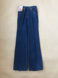 Lee Bootcut Jean from the 70s with original tags still attached Sized W29 L34 in 100% washed cotton denim, Made in Belgium  Mid to high rise with a bootcut leg Talon 42 zipper, front and back pockets Unworn, originating from the archive of a closed down jeans shop Measurements To help make sure the item will fit; use a soft tape measure and compare these with your own or on an item in a similar style. These measurements are just a guide, if you are uncertain please contact us with your measurements and we can advise best fit. Waist: 38cm x 2 Front rise: 28,5cm  Seat: 46cm x 2 Inseam: 90cm Dimensions are taken with the item laying flat on a smooth surface and stretching it out to its full width and length. 1970s Style Straight Leg Medium Wash Jeans, 1970s Fitted Jeans With Pockets, Fitted 1970s Style Jeans, 1970s Fitted Jeans, 1970s High Rise Fitted Bottoms, Classic Full Length Flare Jeans With Belt Loops, Classic Blue Flare Full-length Jeans, Classic Blue Full Length Flare Jeans, Fitted Vintage Flare Jeans With Five Pockets