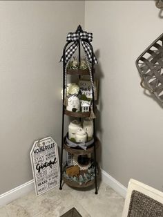 the corner of a bathroom with a shelf filled with items