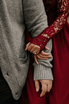 an engaged couple holding hands while standing next to each other