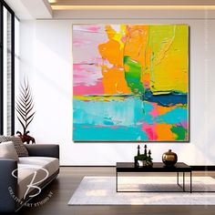 an abstract painting hangs in the living room