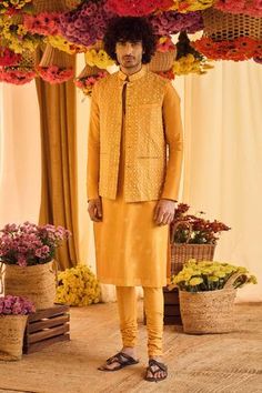 Mustard yellow bundi featuring resham and mirror work. Paired with printed kurta and churidar.
Component: 3
Embroidered, Printed
Neckline: Bundi: Band Collar
Sleeve Length: Bundi: Sleeveless, Kurta: Full Sleeves
Fabric: Chanderi Silk
Color: Yellow
Mirror, resham embroidered bundi
Pocketed bundi
Printed kurta
Side slit kurta
Front button down bundi - Aza Fashions Khadi Kurta, Punit Balana, Yellow Mirrors, Nehru Jackets, Indian Fashion Designers, Mens Designer Fashion, Mirror Work, Embroidered Jacket, Churidar