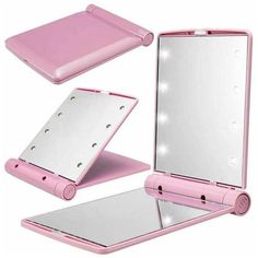 a pink electronic device with its lights on and mirror next to it's case