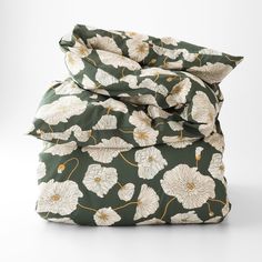 an image of a bed set with flowers on it in green and white color scheme