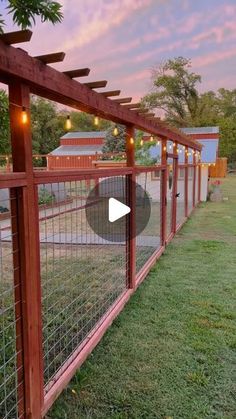 a fence that has lights on it and some grass in front of it with the words,