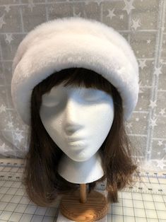 "I made this beautiful Snow White hat out of soft white beaver faux fur and white fleece. The brim is a 3 1/2 inch frame of white beaver faux fur and the hat is lined with a double layer of white fleece for warmth and comfort. Sized to fit most adults 22\"-23\" around head. The hat is a comfortable fit on my 22 1/2\" head. Spot clean or dry clean. Handmade in Albany, Oregon by me!" White Wide Brim Mini Hat For Winter, White Cloche Hat With Short Brim For Winter, White Curved Brim Hat For Winter, White Cloche Hat With Curved Brim For Winter, White Cloche Cap For Winter, White Cloche Hat With Short Brim, White Beanie Costume Hat For Winter, White Beanie For Winter Costume, White Beanie For Winter Festival