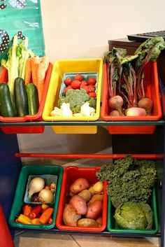 several trays filled with different types of fruits and veggies next to each other