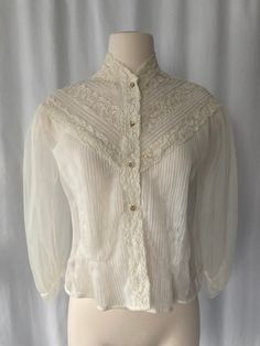 "Sweet cute 1950's women's white sheer button-down pintucked blouse with lace decoration, puffy bishop sleeves and sparkly buttons by Sir James Made in California Good vintage condition with small snags on back and stain on front and 2nd & 3rd button have lost their sparkles No size tag Measurements (laying flat): Pit to Pit: 17 1/2\" Back Length w/o Collar: 1/ 1/2\" Our items are vintage, older and/or pre-loved and may show signs of age. Items may have some imperfections, including small holes, 1950 Women, Sheer White Blouse, Lace Decor, Sheer Blouse, Size Tag, Womens Clothing Tops, Blouses For Women, Bathing Beauties, Stain