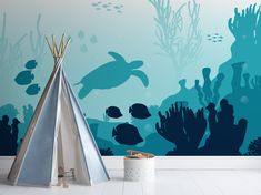 an ocean scene with a teepee tent and sea turtle silhouettes on the wall