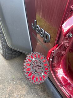 a red jeep parked next to another vehicle