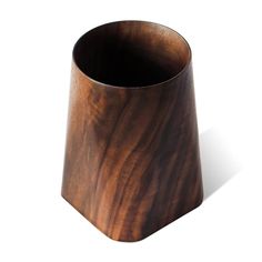 a wooden cup sitting on top of a white table