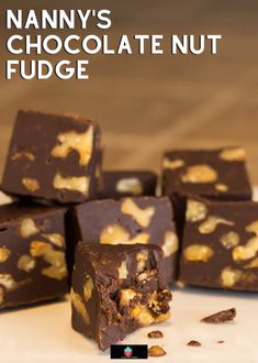 many pieces of chocolate nut fudge on a white surface with the words nanny's chocolate nut fudge