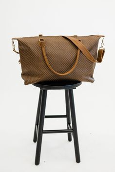 Did someone say must-have bag? The Olivia weekender is an absolute essential in every woman's closet. the timeless patterns, buttery smooth vegan leather, and versatile straps make it a top contender for the title of the perfect travel bag. Details: 26" long x 15" height x 7" wide Detachable strap adjusts to 42" long Gold hardware 3 interior pockets, including 1 with a zipper Adjustable Handle Tote Weekender Bag For Travel, Weekender Tote Bag With Adjustable Handle For Travel, Travel Weekender Tote With Adjustable Handle, Travel Weekender Bag With Adjustable Handle, Brown Weekender Bag With Adjustable Strap For Everyday Use, Brown Travel Luggage With Adjustable Strap, Chic Weekender Bag With Luggage Sleeve, Weekender Satchel Bag With Adjustable Handle For On-the-go, Classic Brown Travel Bag With Adjustable Strap